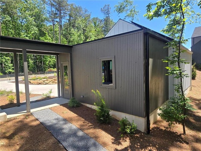 135 Cedarwood Ln, Roswell, GA 30075 - view of side of home featuring board and batten siding and roof mounted solar panels
