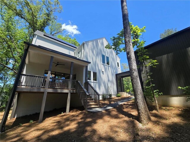 135 Cedarwood Ln, Roswell, GA 30075 - wooden deck featuring an outdoor living space, a ceiling fan, and a forest view