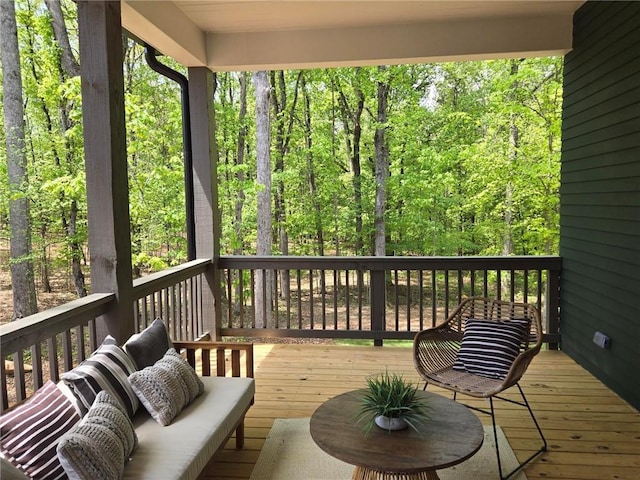 wooden terrace with a wooded view