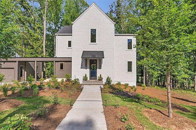 135 Cedarwood Ln, Roswell, GA 30075 - modern farmhouse style home featuring an attached garage, driveway, and metal roof