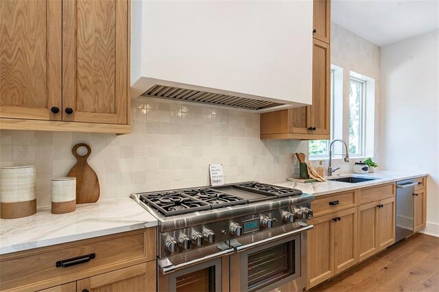 135 Cedarwood Ln, Roswell, GA 30075 - kitchen featuring stainless steel oven, light wood-style floors, light stone countertops, pendant lighting, and baseboards