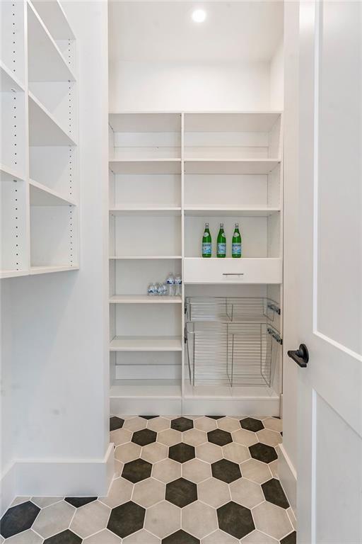 135 Cedarwood Ln, Roswell, GA 30075 - kitchen featuring appliances with stainless steel finishes, custom exhaust hood, light brown cabinetry, a sink, and light wood-style floors
