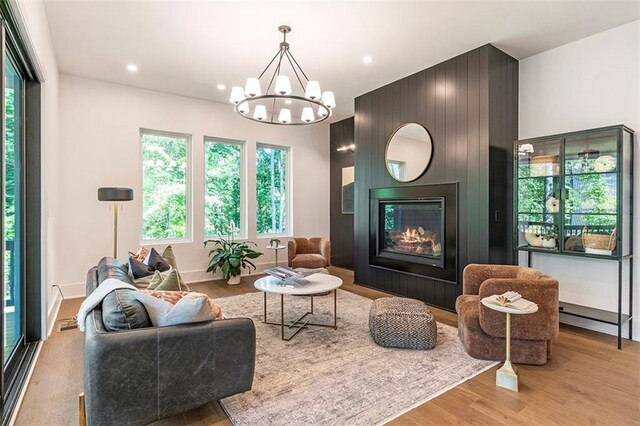 135 Cedarwood Ln, Roswell, GA 30075 - kitchen featuring stainless steel appliances, wall chimney range hood, a sink, baseboards, and light wood-style flooring