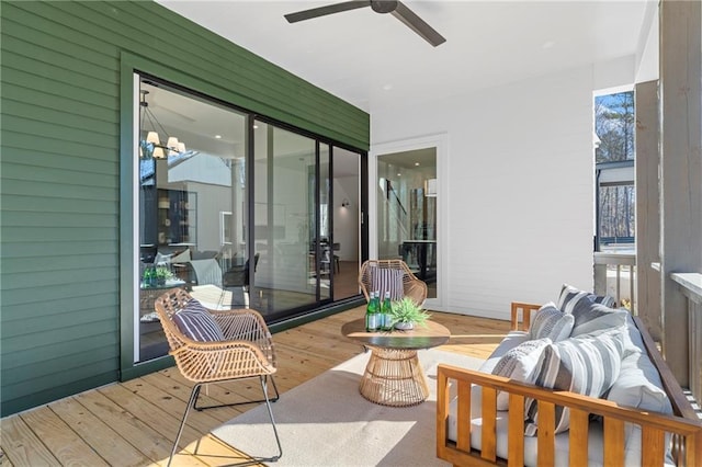 sunroom / solarium with wood finished floors and ceiling fan