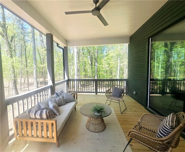 sunroom / solarium featuring a ceiling fan, an outdoor hangout area, and plenty of natural light