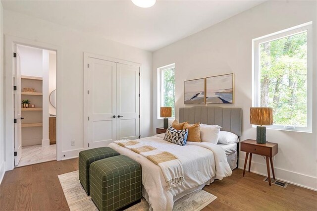 135 Cedarwood Ln, Roswell, GA 30075 - bedroom featuring wood finished floors, baseboards, a closet, and connected bathroom
