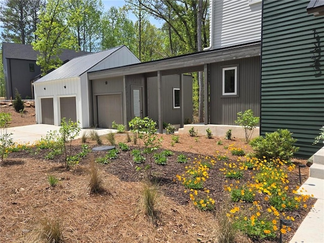 view of front facade with concrete driveway and a garage