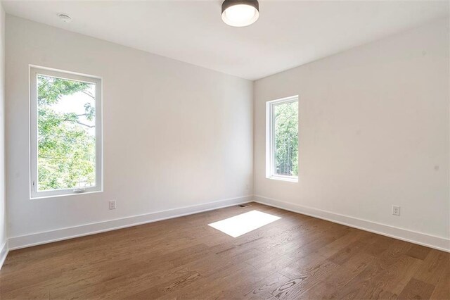 135 Cedarwood Ln, Roswell, GA 30075 - unfurnished room featuring wood finished floors, healthy amount of natural light, recessed lighting, and baseboards