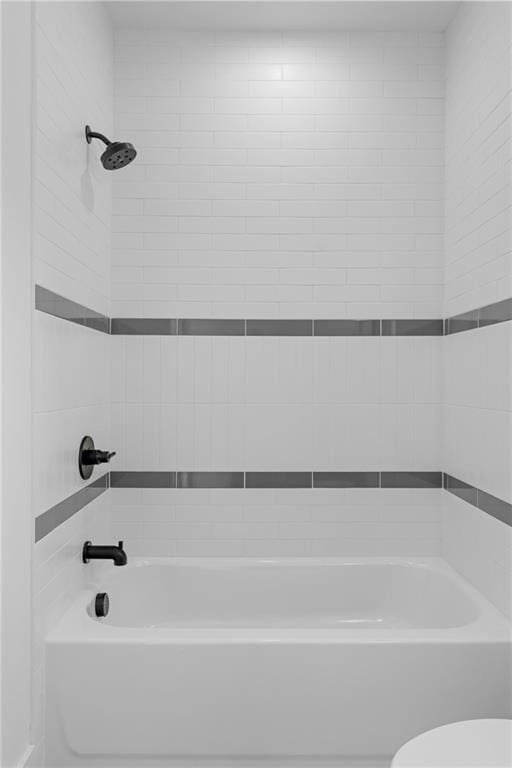 bathroom featuring a bathtub, toilet, and a shower