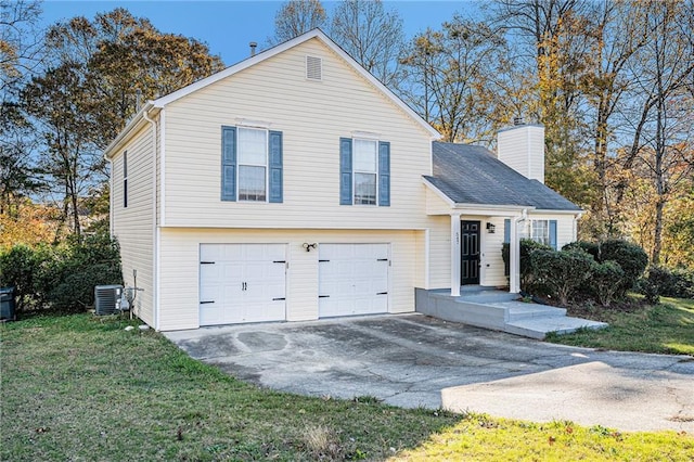 view of front of home with a front yard, a garage, and central AC unit