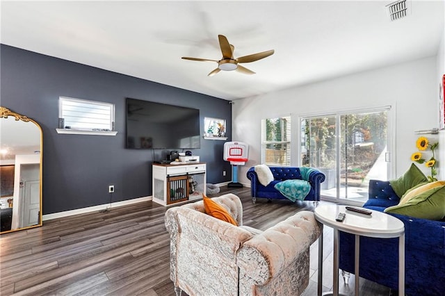 living room featuring ceiling fan and dark hardwood / wood-style floors