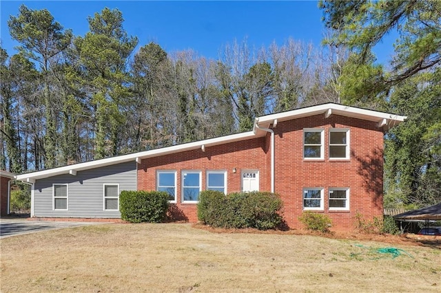 view of front of property with a front yard and brick siding