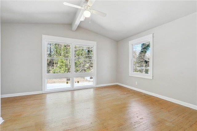 unfurnished room with lofted ceiling with beams, ceiling fan, light wood finished floors, and baseboards