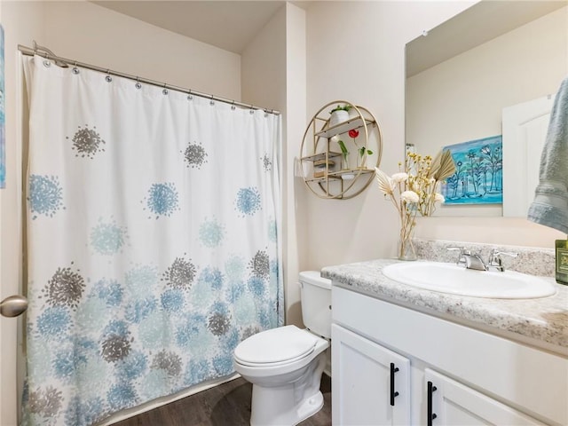 bathroom featuring hardwood / wood-style floors, toilet, and vanity