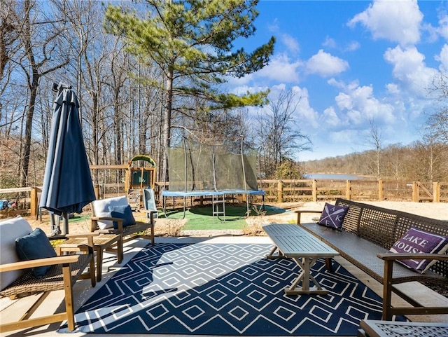 view of patio / terrace with a trampoline, outdoor lounge area, and a playground