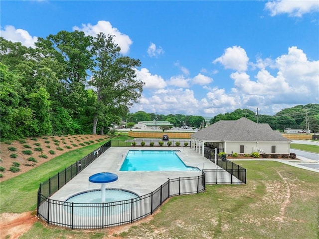 view of pool featuring a patio area, an in ground hot tub, and a lawn