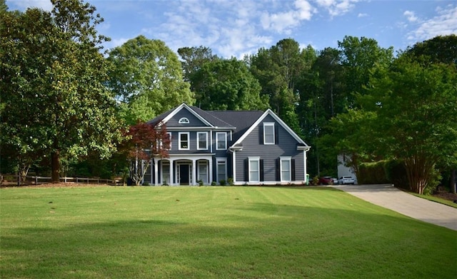 view of front facade with a front lawn, a porch, and concrete driveway