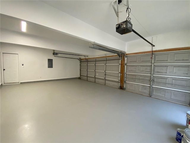 garage with a garage door opener and electric panel