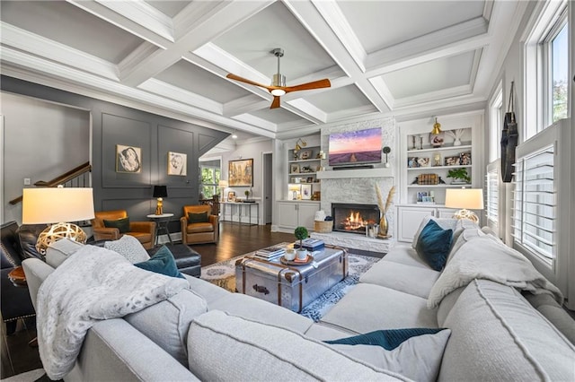 3111 Old Thompson Mill Rd, Buford, GA 30519 - living room featuring wood finished floors, a fireplace, ornamental molding, ceiling fan, and beam ceiling
