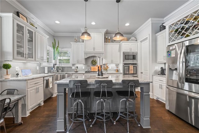 3111 Old Thompson Mill Rd, Buford, GA 30519 - kitchen with stainless steel appliances, white cabinets, dark wood-style floors, a kitchen island, and recessed lighting