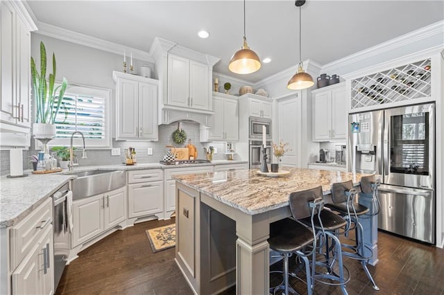 3111 Old Thompson Mill Rd, Buford, GA 30519 - kitchen with stainless steel appliances, a sink, a center island, white cabinetry, and recessed lighting