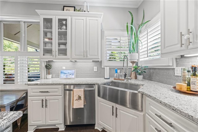 3111 Old Thompson Mill Rd, Buford, GA 30519 - kitchen with stainless steel dishwasher, a sink, white cabinets, ornamental molding, and decorative backsplash