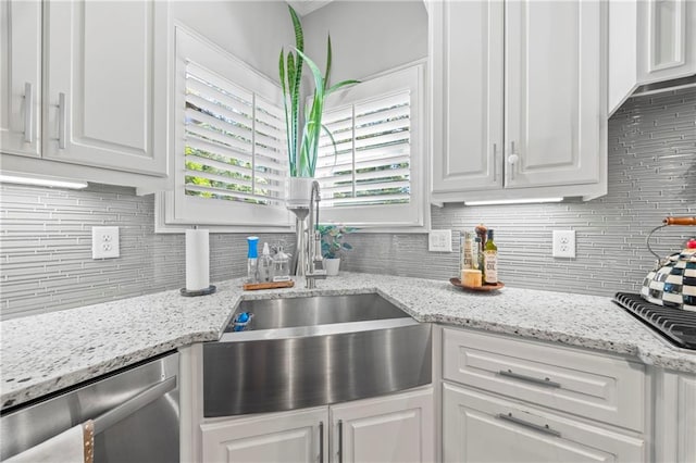 3111 Old Thompson Mill Rd, Buford, GA 30519 - kitchen featuring stainless steel dishwasher, backsplash, a sink, white cabinets, and light stone counters