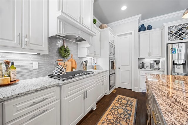 3111 Old Thompson Mill Rd, Buford, GA 30519 - kitchen featuring stainless steel appliances, white cabinets, backsplash, crown molding, and dark wood-style floors