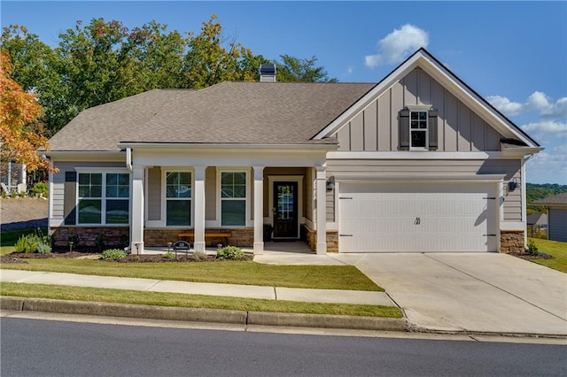 craftsman house with a garage, a porch, and a front lawn