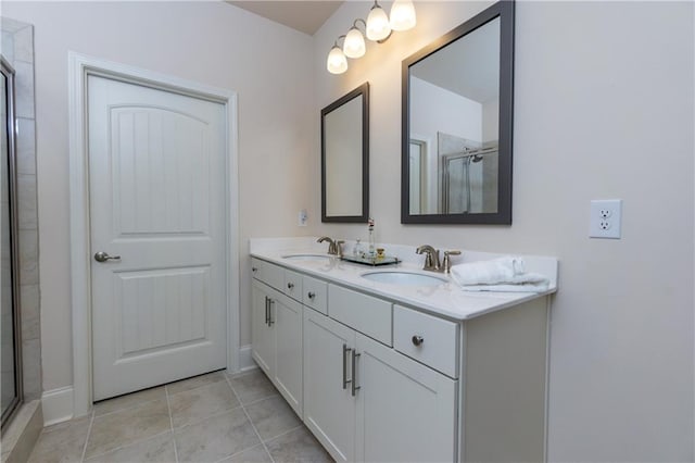 bathroom featuring vanity, an enclosed shower, and tile patterned floors