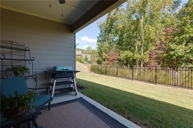 view of yard with ceiling fan and a patio area