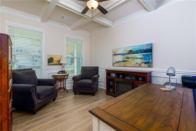 living room featuring light hardwood / wood-style floors, ceiling fan, beam ceiling, crown molding, and coffered ceiling