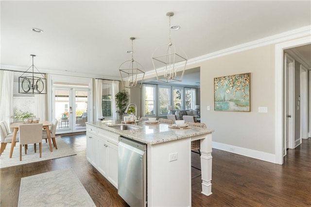 kitchen featuring a notable chandelier, white cabinetry, stainless steel dishwasher, sink, and an island with sink