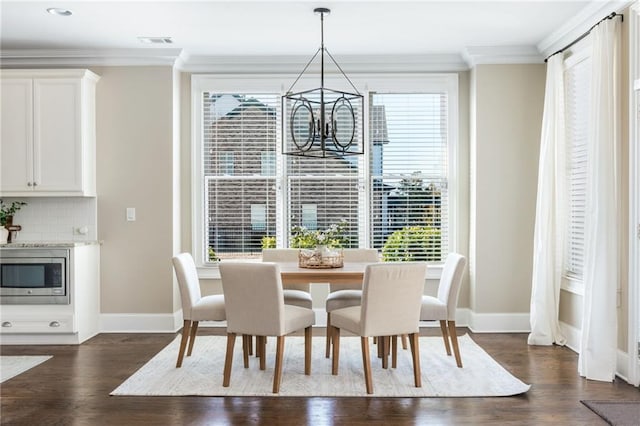 dining room with a chandelier, crown molding, and plenty of natural light