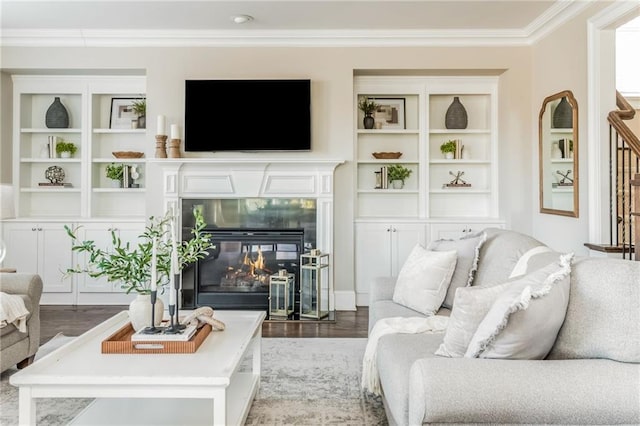 living room featuring ornamental molding, hardwood / wood-style flooring, and a premium fireplace