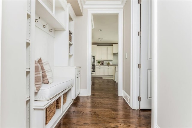 mudroom with crown molding and dark hardwood / wood-style floors