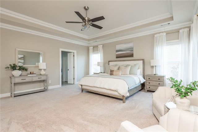 bedroom with ornamental molding, ceiling fan, a raised ceiling, and light colored carpet