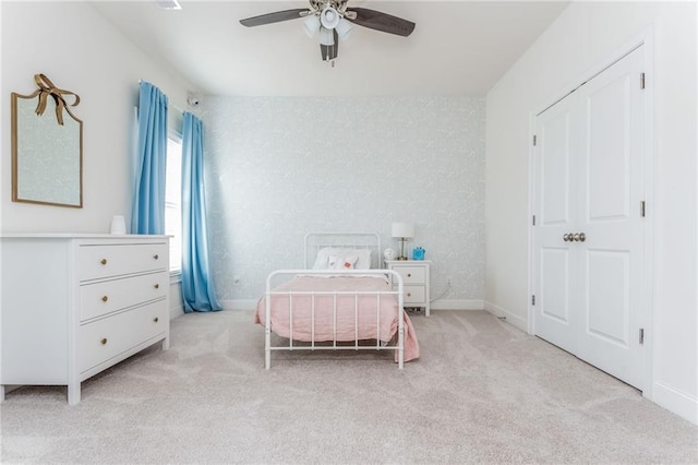 bedroom with light colored carpet and ceiling fan