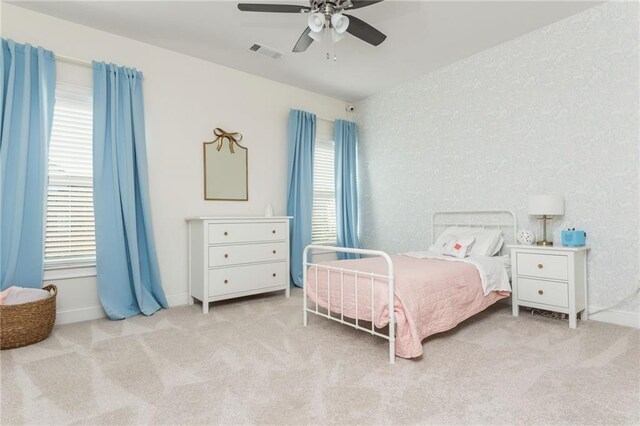 carpeted bedroom with ceiling fan