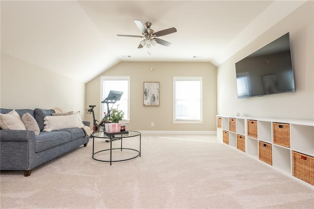 carpeted living room featuring vaulted ceiling and ceiling fan