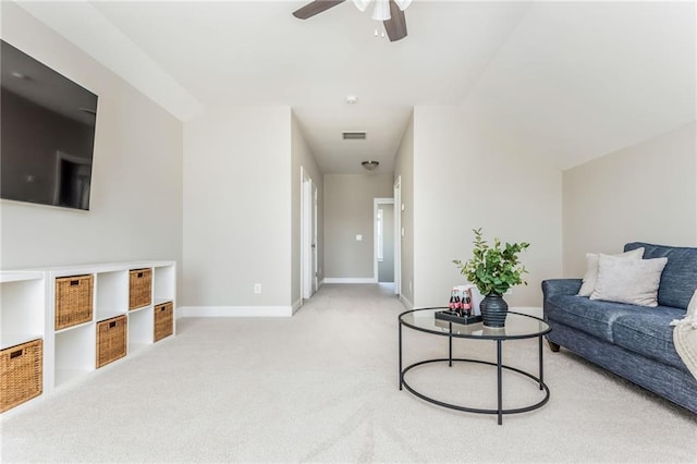 carpeted living room featuring vaulted ceiling and ceiling fan