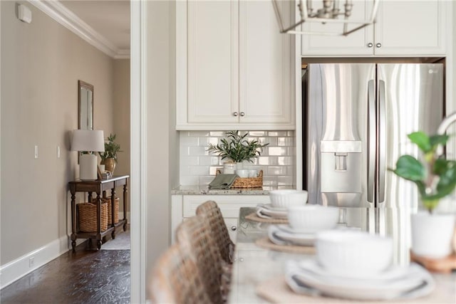 dining room featuring crown molding and dark wood-type flooring