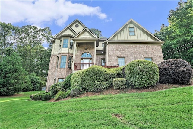3641 Mountain Cove Rd, Snellville, GA 30039 - view of front of property with brick siding, a front lawn, and board and batten siding