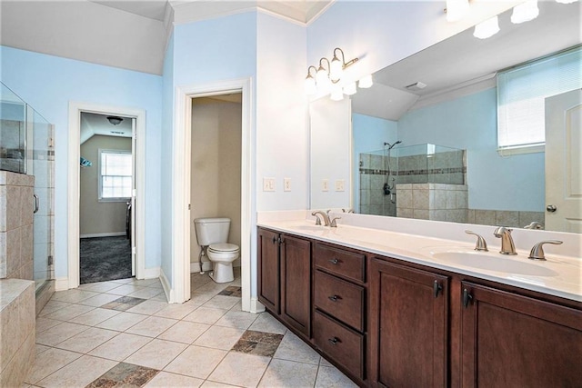 3641 Mountain Cove Rd, Snellville, GA 30039 - bathroom featuring a shower stall, tile patterned flooring, toilet, double vanity, and crown molding