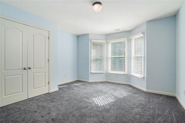 3641 Mountain Cove Rd, Snellville, GA 30039 - unfurnished bedroom featuring carpet flooring, baseboards, and a closet
