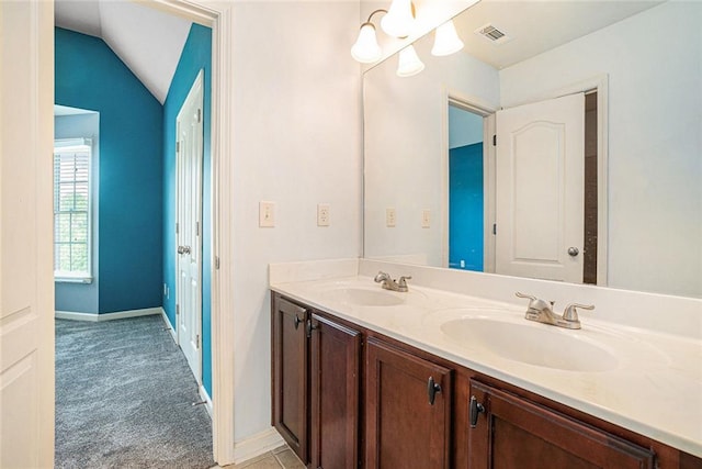 3641 Mountain Cove Rd, Snellville, GA 30039 - bathroom featuring double vanity, baseboards, and lofted ceiling