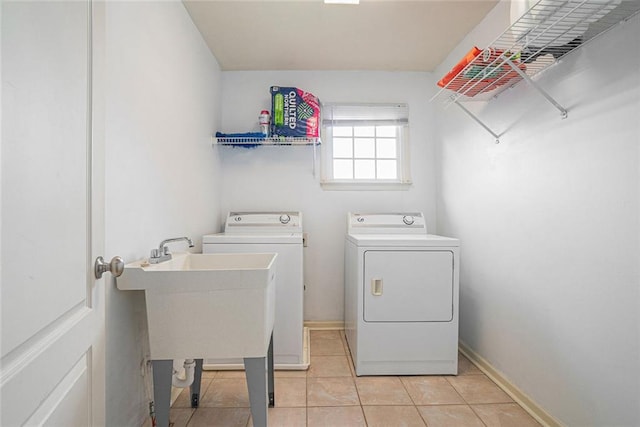 3641 Mountain Cove Rd, Snellville, GA 30039 - washroom with washing machine and dryer, light tile patterned floors, and baseboards
