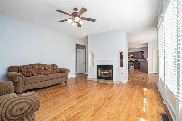 3641 Mountain Cove Rd, Snellville, GA 30039 - living room featuring a ceiling fan, a glass covered fireplace, light wood-style floors, and recessed lighting