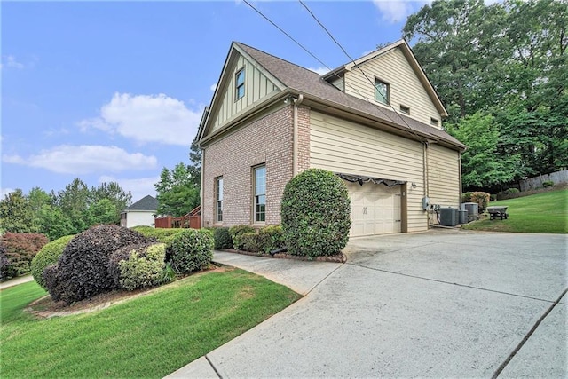 3641 Mountain Cove Rd, Snellville, GA 30039 - view of property exterior featuring brick siding, board and batten siding, concrete driveway, a yard, and cooling unit