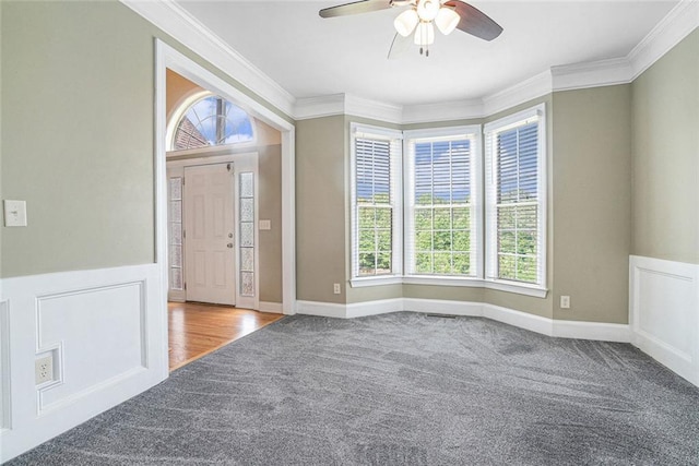 3641 Mountain Cove Rd, Snellville, GA 30039 - entrance foyer featuring carpet floors, crown molding, plenty of natural light, a ceiling fan, and wainscoting